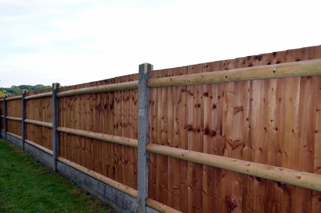 a dark brown wooden fence